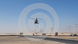 Police helicopter in the desert. Police training and rescue operation concept.