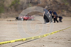 police line do no cross with blurred car and group of law enforcement background