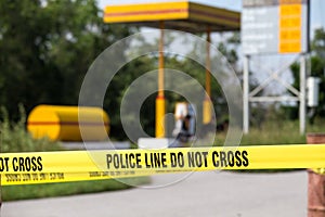 police line do no cross with gas station background in crime scene