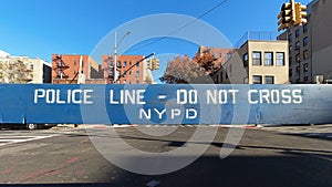 Police line, do not cross, NYPD blue wooden barricade on closed street in the Bronx, New York City