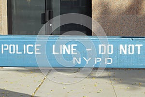 Police line, do not cross, NYPD blue wooden barricade on closed street in the Bronx, New York City