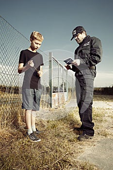 Police man questioning a teenage boy