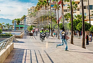 Police on a motorbikes in pursuit of the street vendor