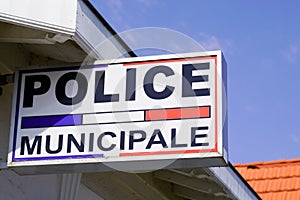 Police municipale means in french Municipal police Station with flag and text sign