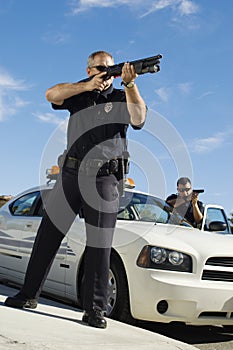 Police Officer Aiming Shotgun