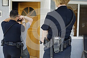 Police Officer Arresting Young Man photo