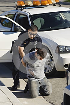 Police Officer Arresting Young Man