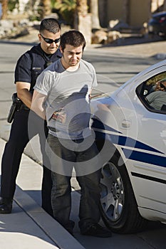 Police Officer Arresting Young Man