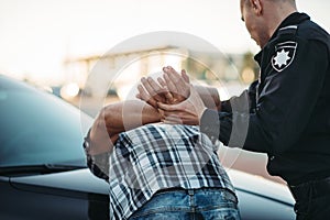 Police officer arrests the driver violator on road photo