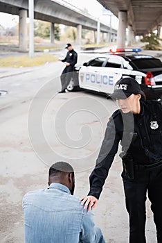 Police officer calming african american man
