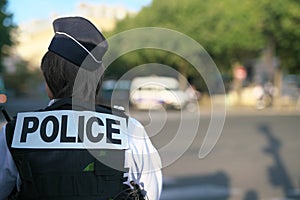 A police officer on duty near au Change bridge on the Seine River