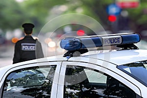 Police officer emergency service car driving street in the city