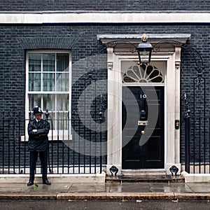 A police officer guards the entrance door of 10 Downing Street in London, UK