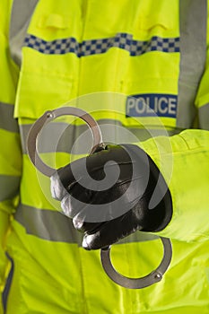 Police officer holding handcuffs