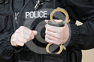 Police officer holding handcuffs