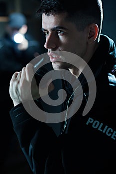 Police officer holding radio
