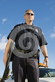 Police Officer Holding Weapon