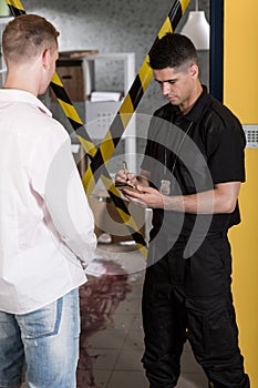 Police officer interrogating witness