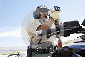Police Officer Looking Through Radar Gun photo