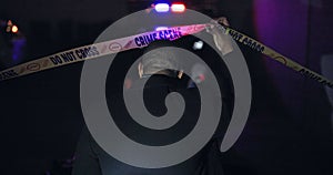 Police officer, man and yellow tape for crime scene, investigation or back in night, warning and danger sign. Forensic