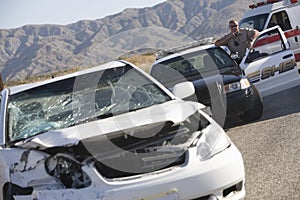 Police Officer At Scene Of Car Crash