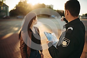 Police officer shows parking place to driver