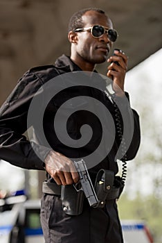 police officer talking by walkie-talkie radio set