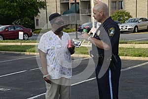 A police officer talks to an African American at a community events