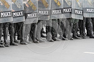 Police officer team with weapons and riot shield protection. Violence Against Demonstrators and protesters during COVID-19