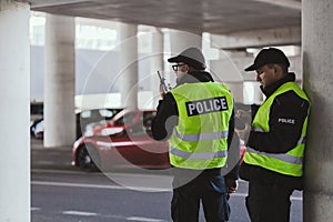 Police officers in black uniforms and yellow vests