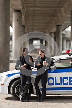 police officers with coffee and doughnuts standing next