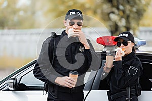 Police officers in sunglasses eating burgers