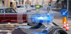 Police patrol car with blue sirens during a traffic control