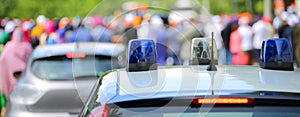 Police patrol car with flashing lights and a police car undercover in the city