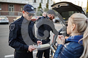 Police patrol stop woman and checking car