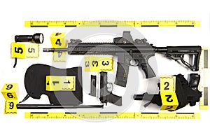 Police photo evidence of seized automatic gun and other weapons and contraband