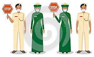 Police and quarantine concept. Couple of muslim arabian policeman and policewoman in traditional uniforms and protective masks