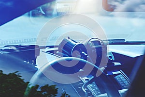 Police radar inside of police car. Patrol monitors traffic on a photo