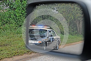 Police in rear view mirror