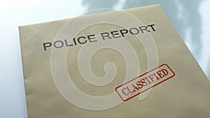 Police report classified, seal stamped on folder with important documents