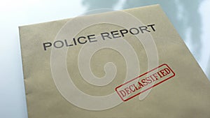 Police report declassified, seal stamped on folder with important documents photo