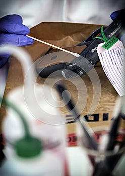 Police scientist analyzes gunpowder evidence with isopo in crime lab
