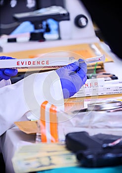 Police scientist pulls out isope with sample of evidence implicated in murder