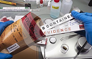 Police scientist takes evidence swab bag boxes to analyse for traces of dna from homicide in crime lab