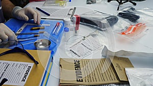 Police scientist working in Criminalistic Laboratory, bullet shell analysis