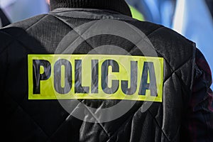 Police sign / logo on the uniform.