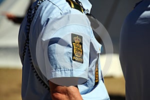 Police sign on police officers arm