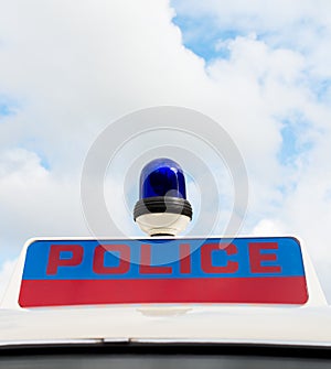 Police sign on police patrol car.