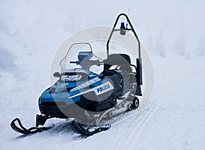 Police snowmobile in the mountains