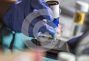 Police specialist examines wallet to collate DNA in a crime scene